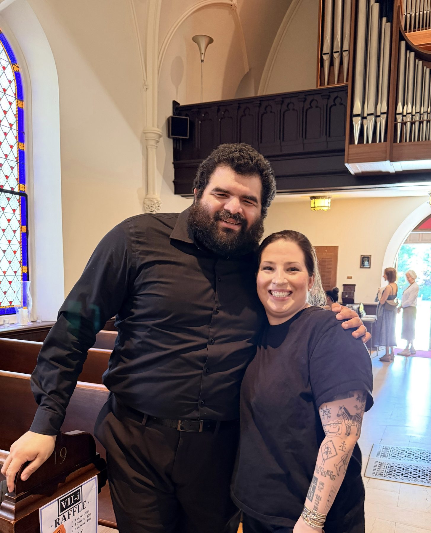 Two ensemble members pose inside a church