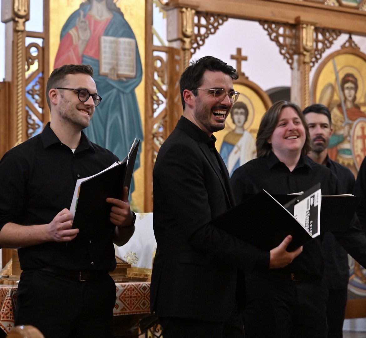 Ensemble members laugh together after singing