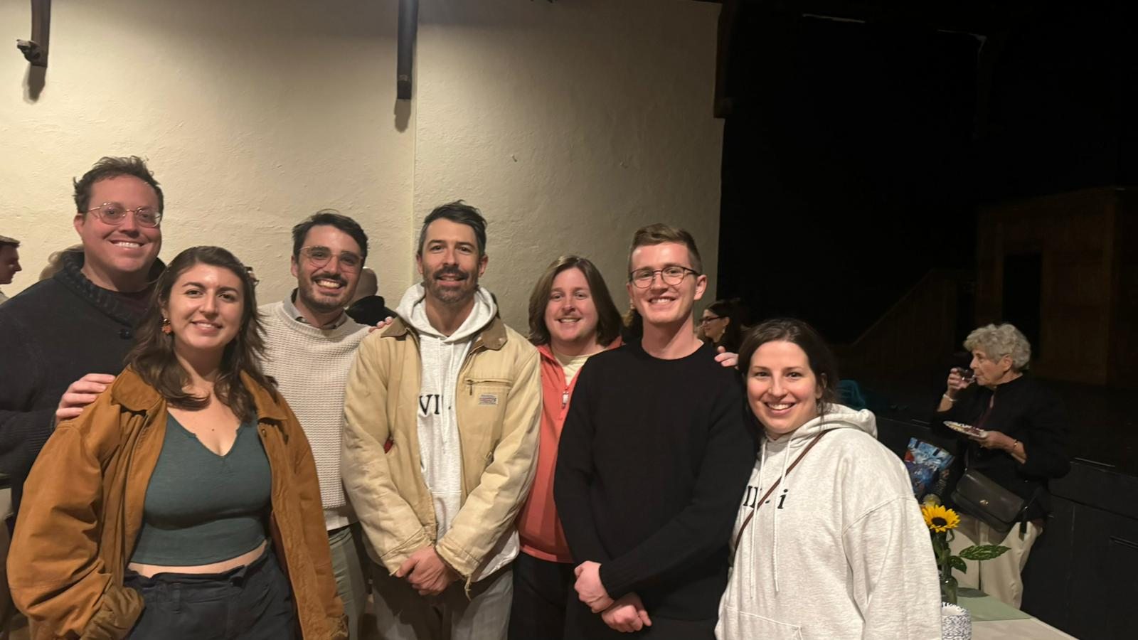 Ensemble members smile together at an event